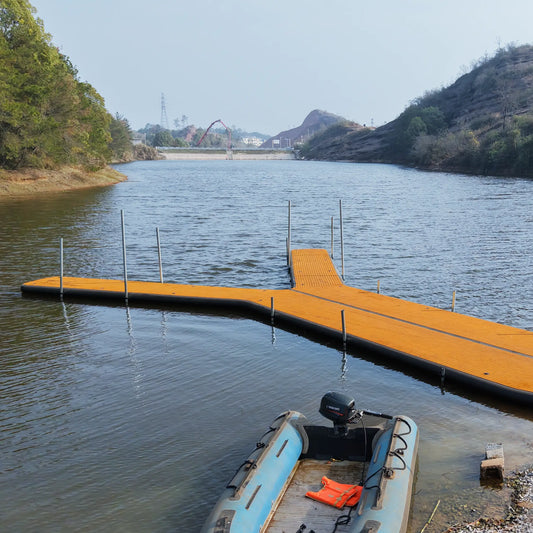 Side view of AirJain inflatable floating dock on water during field testing. Shows high stability and rigid walkway platform for boat maintenance and cleaning.
