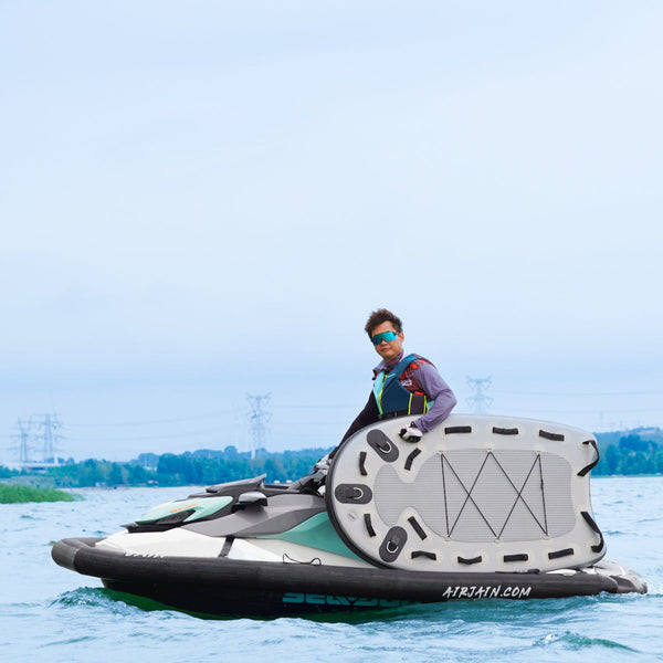 AirJain sled board for jet skis, designed for water sports, shown in use with a Sea-Doo jet ski for enhanced stability and performance during towing and sliding activities