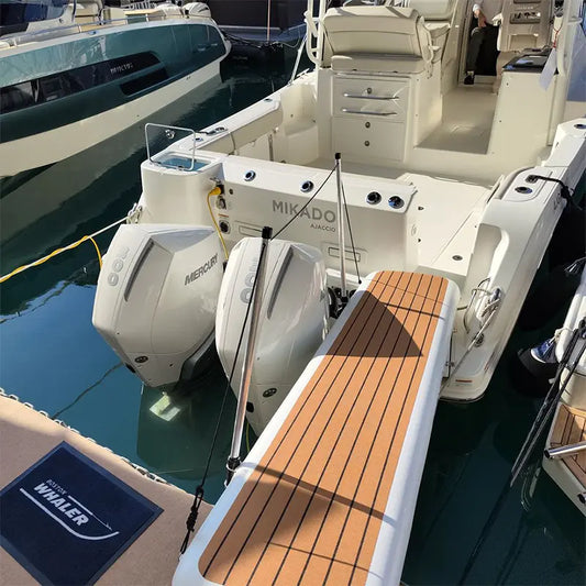 Inflatable yacht gangway used as a stable boarding ramp connecting a luxury boat to the marina dock.