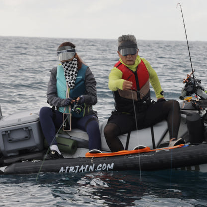 Two people fishing safely on one side of a jet ski, supported by a durable Airjain jet ski collar preventing the watercraft from rolling.